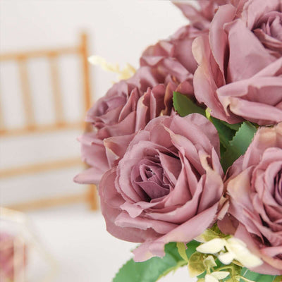 Purple artificial roses in a bouquet arrangement.