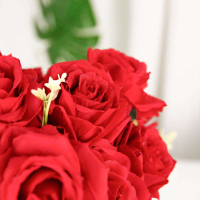 Red artificial roses bouquet with white accents in a close-up shot.