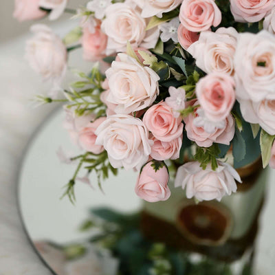 Pink artificial roses bouquet in a decorative vase.