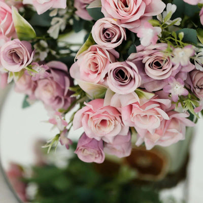 Pink roses bouquet with delicate flowers in a mirror reflection.