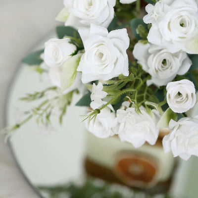 White artificial roses arranged in a bouquet.