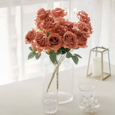 Bouquet of peach roses in a glass vase on a table