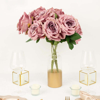 Pink roses in a glass vase with gold accents, elegantly arranged for a table setting.