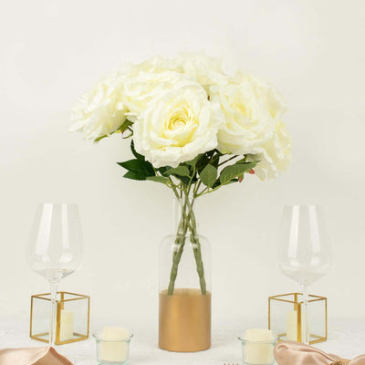 White rose bouquet in a glass vase with gold accents, elegantly displayed.