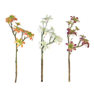 Artificial succulent stems in three colors on a white background.