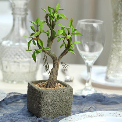 Artificial bonsai tree in a textured pot, perfect for home decor.