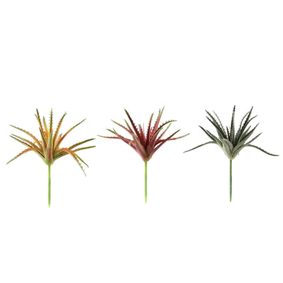 Artificial aloe vera plants in vibrant colors on a white background