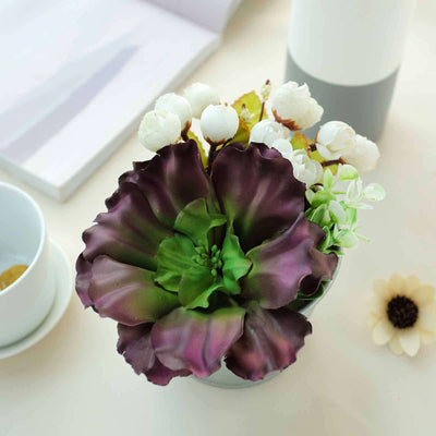 Artificial succulent arrangement in a decorative pot.
