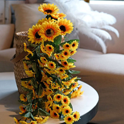 Artificial sunflower garland with vibrant yellow blooms in a decorative basket.