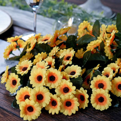Yellow artificial sunflowers with dark centers, arranged on a wooden table.
