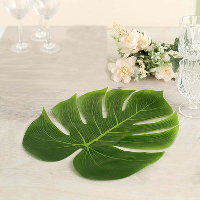 Monstera leaf decoration on a table with floral accents.
