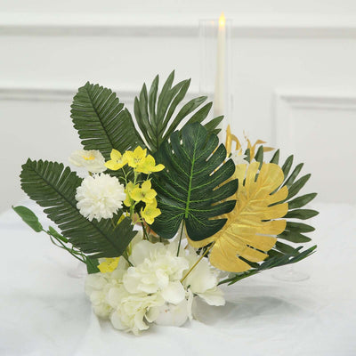 Artificial floral arrangement with green leaves and yellow accents.