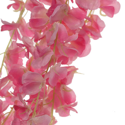 Pink artificial flower garland on a plain background