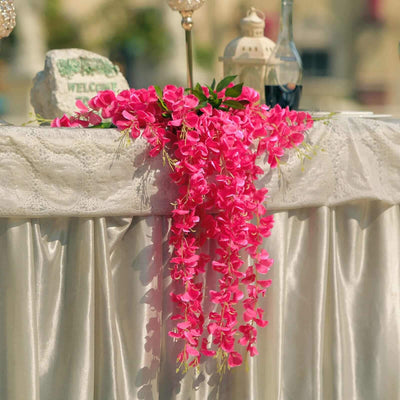 Pink floral garland draping elegantly over a tablecloth.