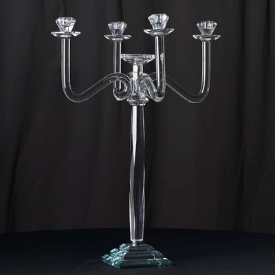 Elegant crystal candelabra with four candle holders on a sleek base.