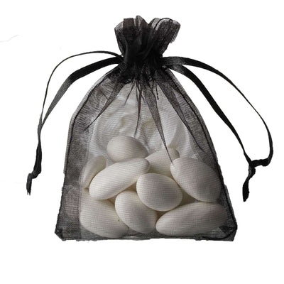 White candy-coated almonds in a black organza bag.