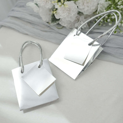 Silver gift bags with handles on a light background.