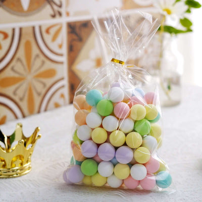 Colorful pastel candy balls in a clear bag on a table.