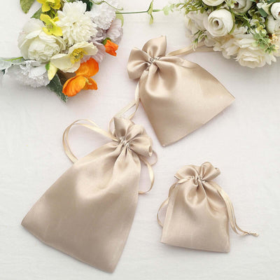 Set of elegant beige satin gift bags with bows