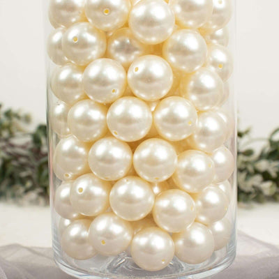 White decorative pearls in a clear glass jar.