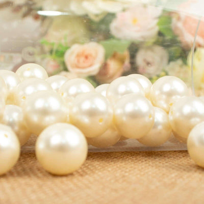 Pearl-like decorative beads in a clear container.