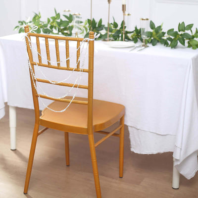 Elegant gold chair with decorative beads, set for a stylish dining scene.