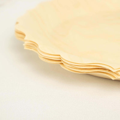 Scalloped edge disposable wooden plates stacked neatly