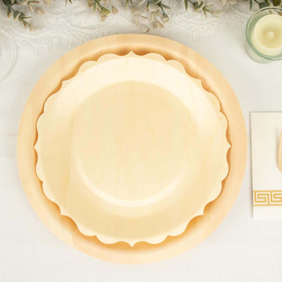 Scalloped edge plates in cream color stacked on a table.