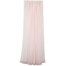 A blush chiffon and polyester solid backdrop curtain is hanging on a white wall