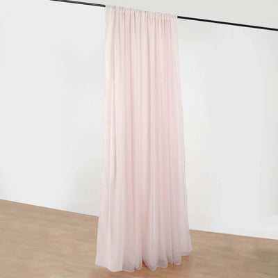 Light pink sheer curtain draped on a rod, showcasing its flowy fabric.