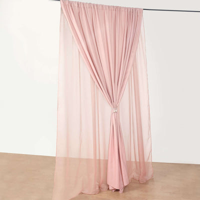 Pink sheer curtain draped elegantly with a tieback against a plain backdrop.