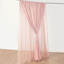 A dusty rose chiffon and polyester curtain hanging on a metal rod, perfect for room divider, solid backdrop curtain & dividers