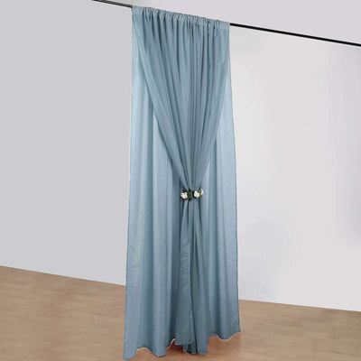Light blue curtain with floral tieback, elegantly draped.