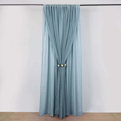 Light blue curtain draped with floral tieback against a plain background.
