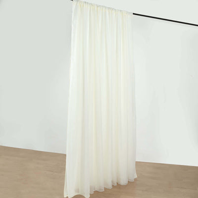 Sheer white curtain draped on a rod for elegant window treatment