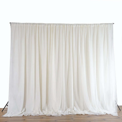 White backdrop curtain draped elegantly, perfect for events and photo shoots.