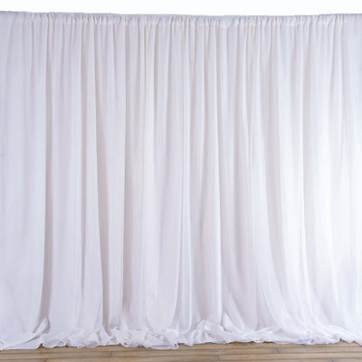 White sheer fabric backdrop draped elegantly in a studio setting