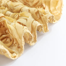 A close up of a Champagne Satin 3D Rosette ruffled fabric on a white surface