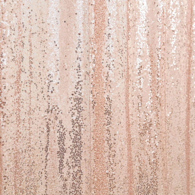 Rose gold sequin fabric with shimmering texture and sparkle.