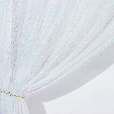 Sheer white glitter curtain draped elegantly with a gold tie.