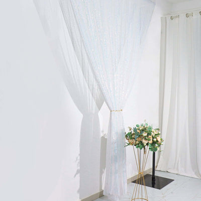 Sheer sparkling curtain draped elegantly in a bright room with floral decor.