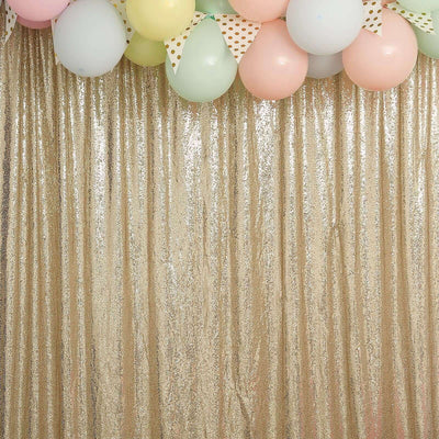 Gold sequin backdrop with colorful balloons for festive celebrations.