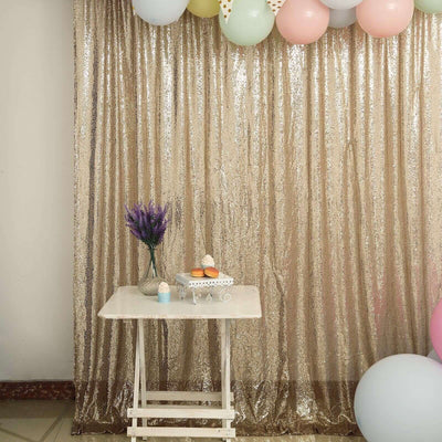 Decorative party setup with balloons, table, and lavender flowers against a shimmering backdrop.