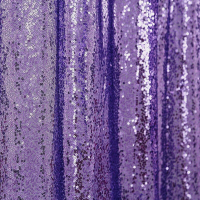 Purple sequin fabric with shimmering texture and detail.