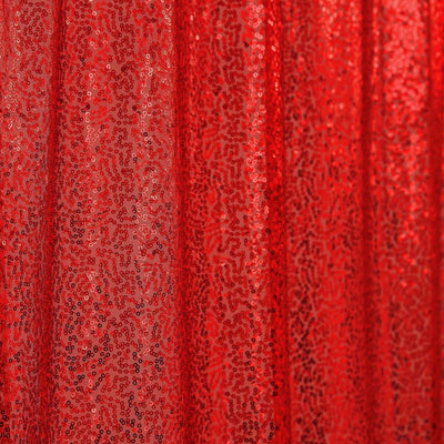 Red sequin fabric draped elegantly, sparkling under light.