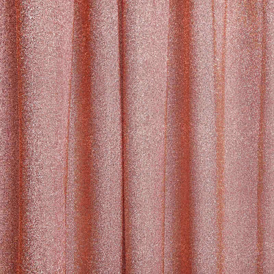 Shimmering rose gold fabric drapes with elegant texture and shine.