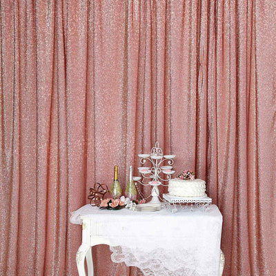 Elegant rose gold sequin backdrop with decorative table and cake display.