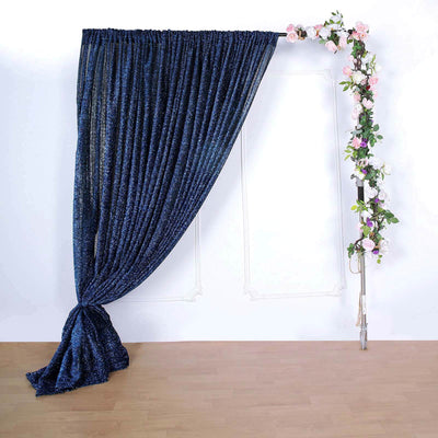 Navy sequin curtain with floral accents on a studio backdrop