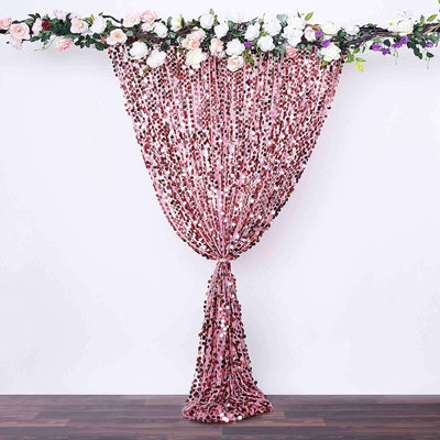 Pink sequin curtain with floral decor for events and photography.