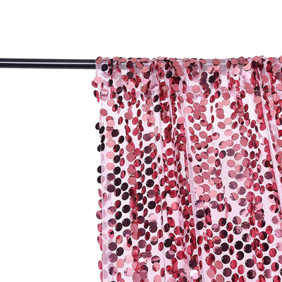 Pink sequin curtain draped on a black rod, creating a sparkling effect.